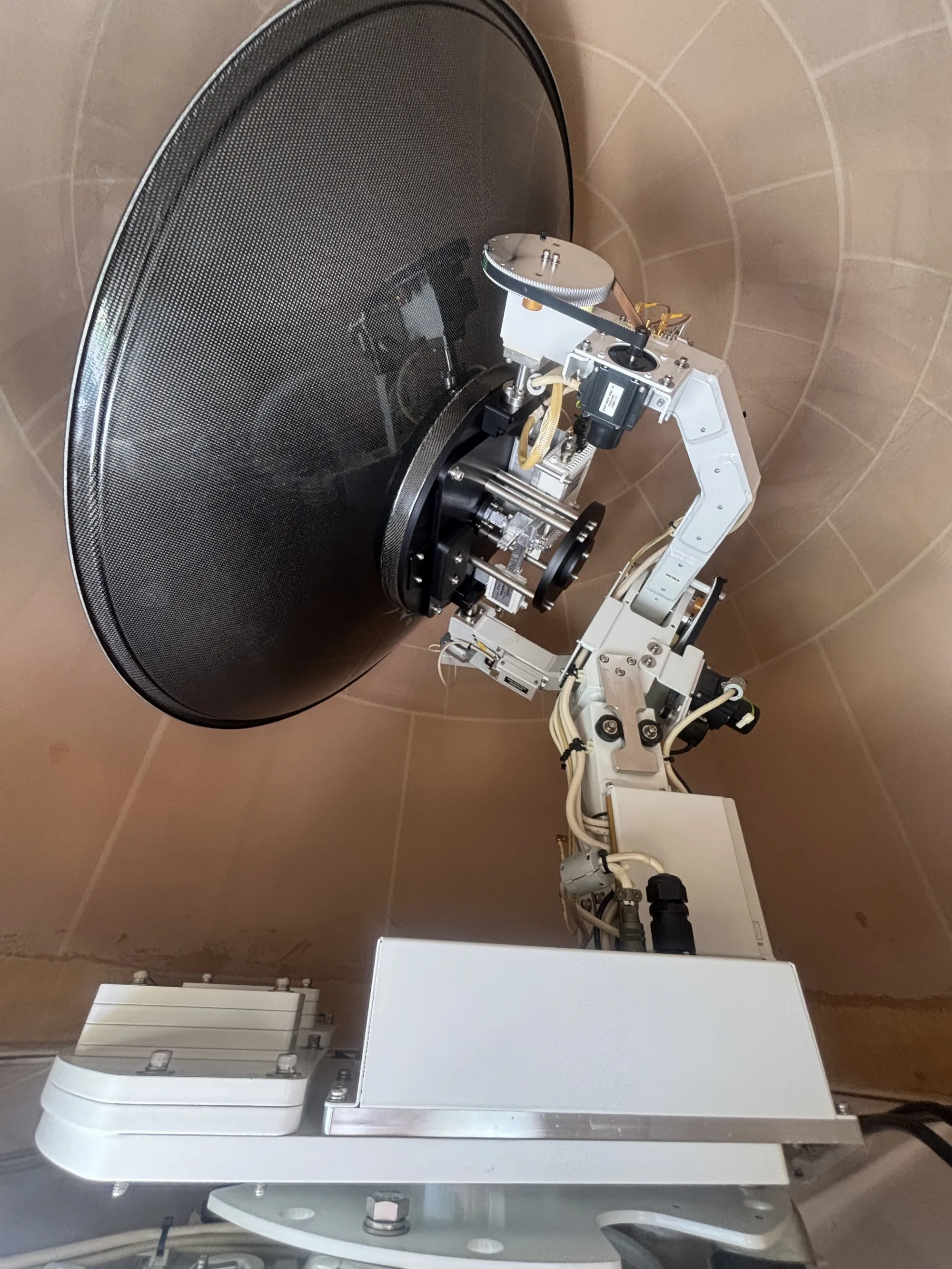 Inside the Intellian GX100 radome: reflector, pedestal and belts during inspection