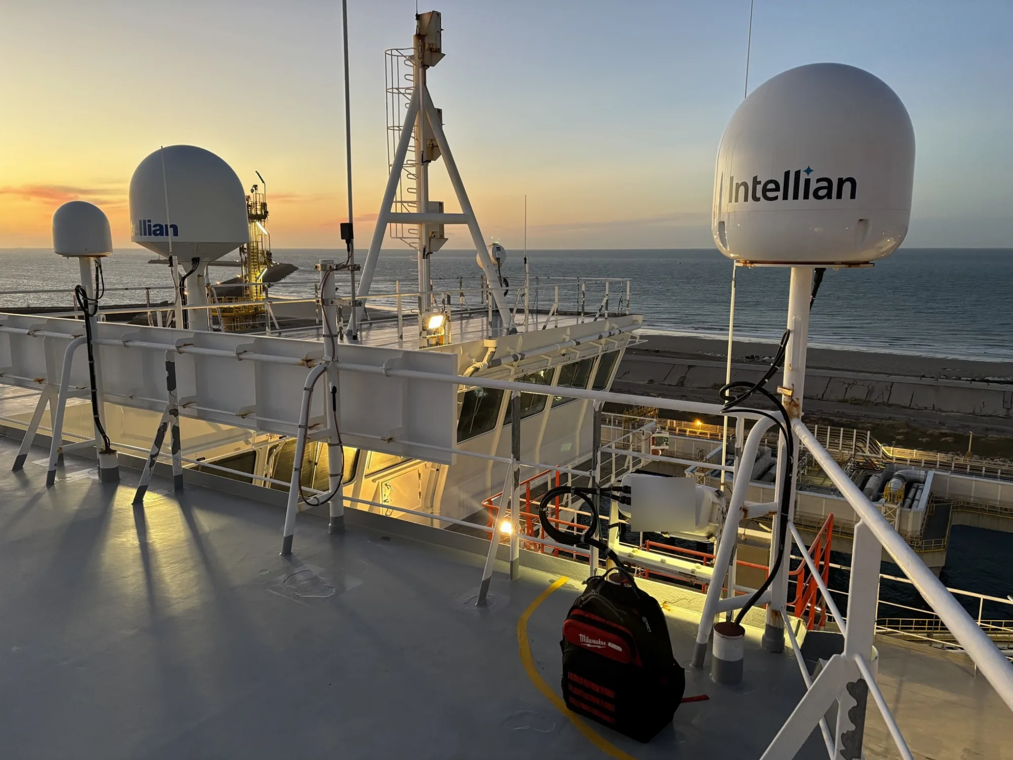 Antenna deck of the LNG carrier with Intellian VSAT radomes at sunset in the Port of Antwerp-Bruges