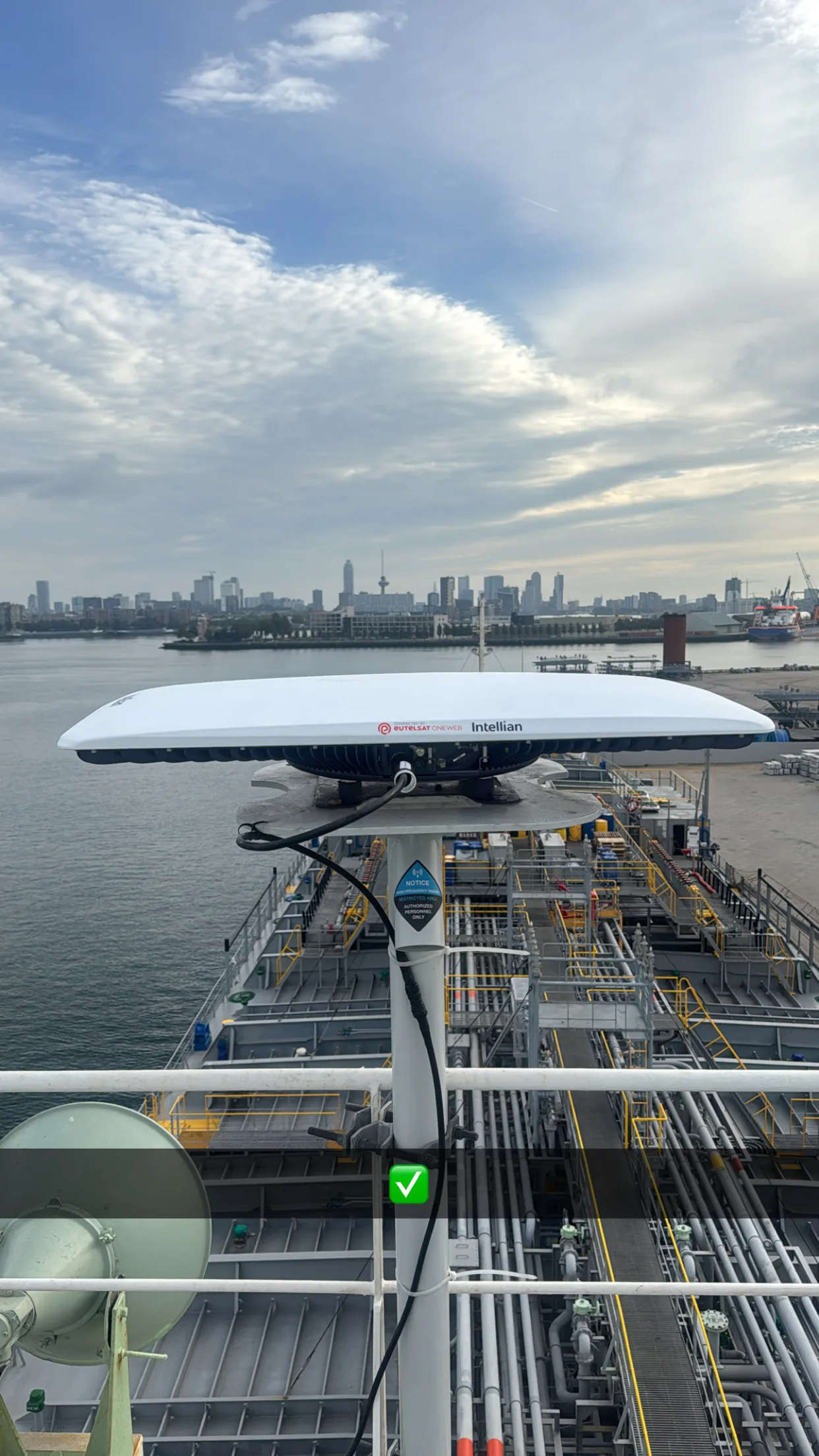 OneWeb antenna on the mast with the Port of Rotterdam in the background