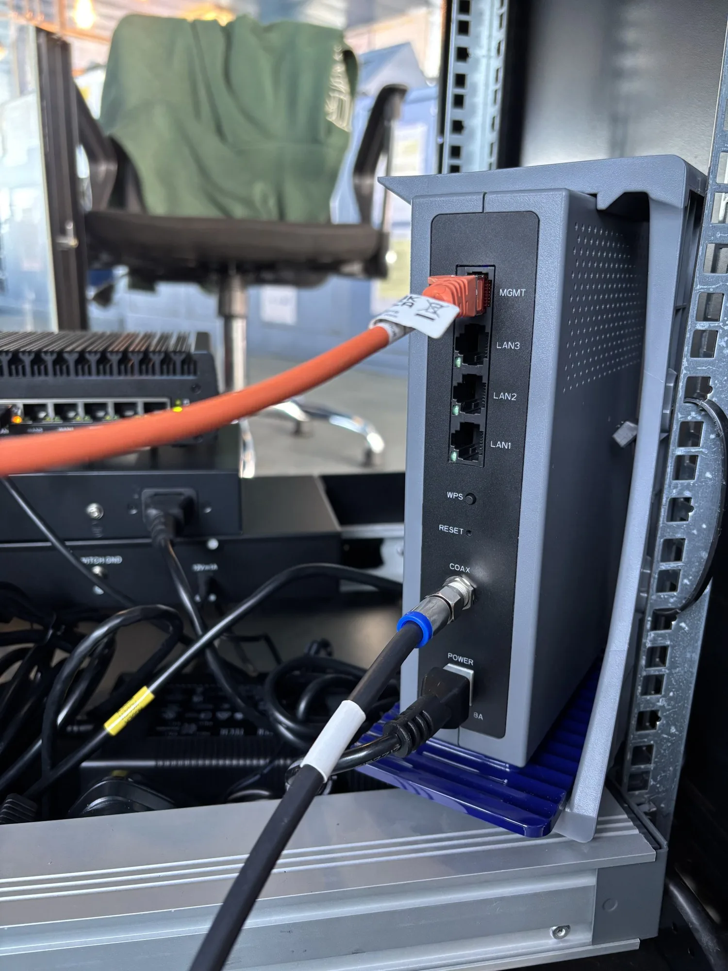 Intellian OW10HM below-deck terminal with LAN, management and coax connections in the rack